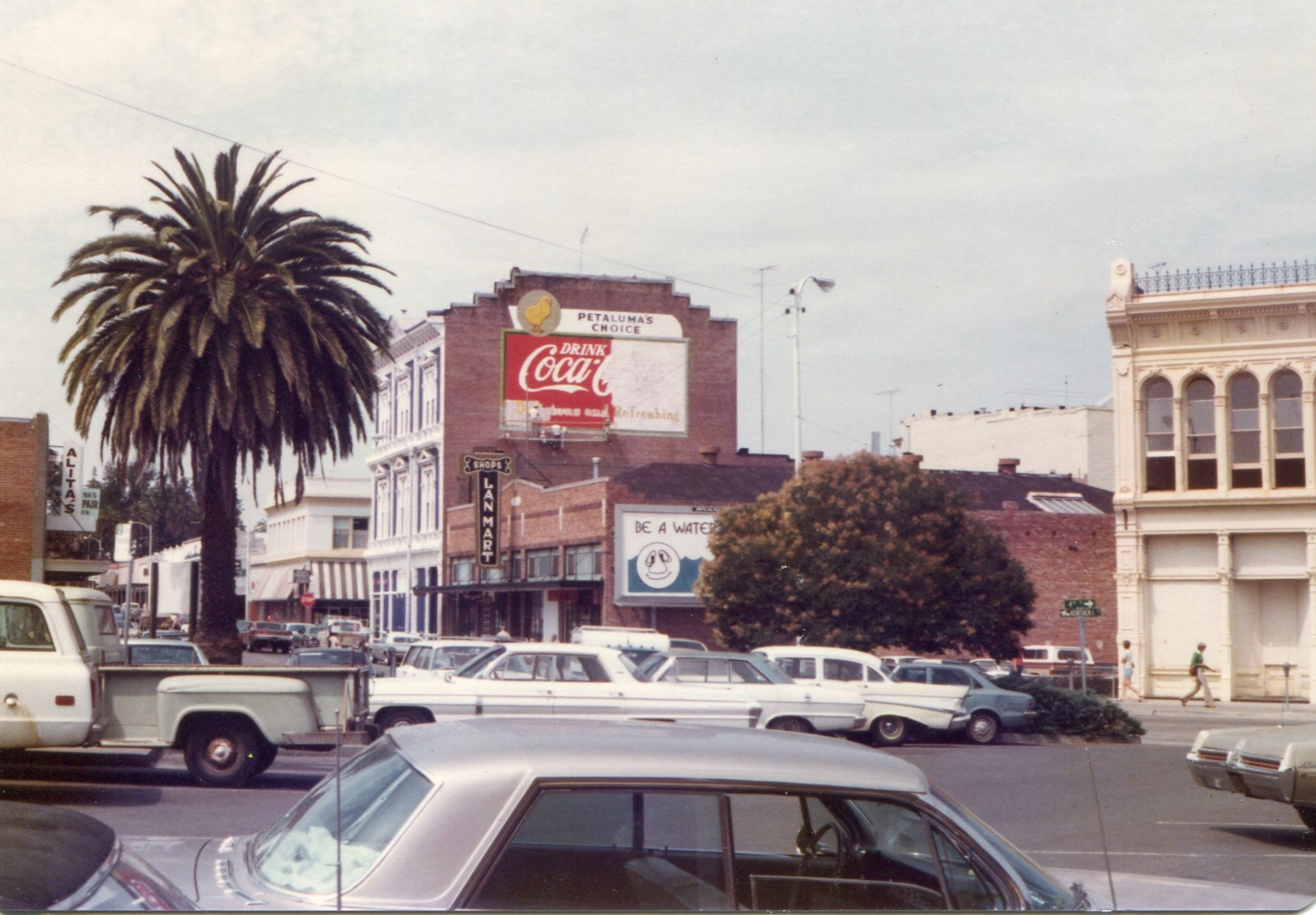 Coca Cola wall sign being repainted on the side of the Mutual Relief Building